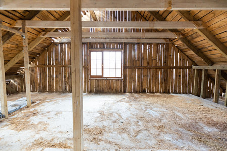 Abandoned building interior in disrepair with debris, exposed pipes, and missing doors awaiting renovationの写真素材