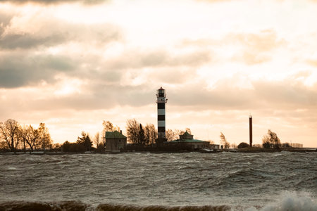 View to the Daugavgriva lighthouse from Mangalsala pier during stormy weather in Riga, Latviaの写真素材