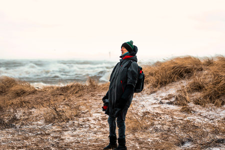 adventurous photographer captures the raw beauty of a coastal storm in winterの写真素材