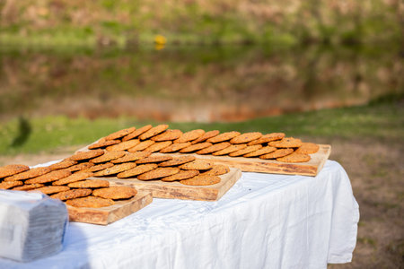 freshly baked oatmeal cookies displayed on wooden boards at an outdoor setting
