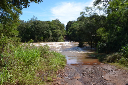 Bridge surpassed by a swollen riverの写真素材