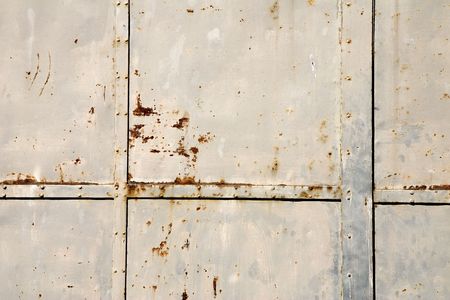 Close-up of a weathered rusty metal door