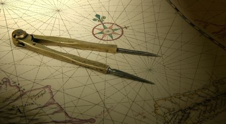Ancient brass dividers on a nautical chart