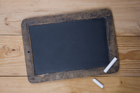 An old blank blackboard and white chalkの写真素材