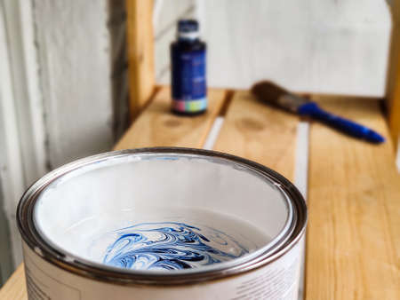 Mixing white and blue paint to paint walls. Home renovation.の写真素材