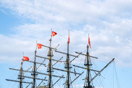 Masts of the ship with turkish flags on the background of the blue sky. The concept of travel and...