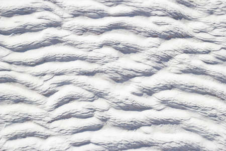 Texture of Pamukkale calcium travertine in Turkey, white pattern of horizontal waves, close-up.の写真素材
