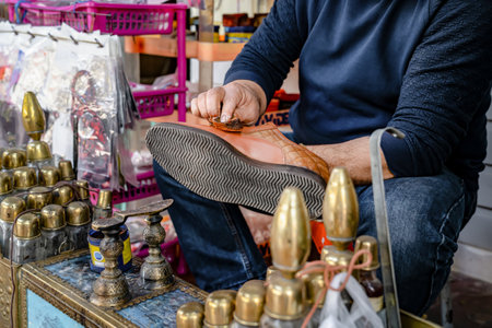 Man cleans shoes with help of shoe polish on street, close up. Ancient method of shoe cleaning.の写真素材