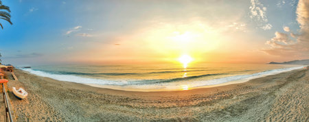 Beautiful sunset over sea coast, view from shore, panorama, banner.の写真素材