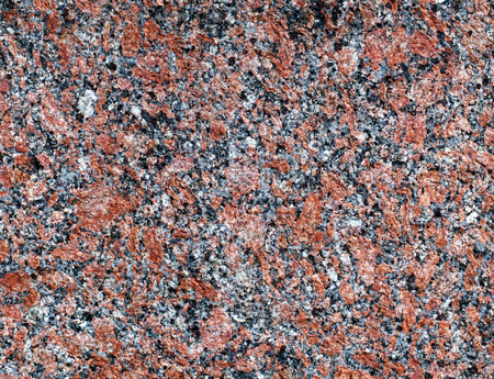 Red granite texture, background or wallpaper. Rough split face stone texture.の写真素材