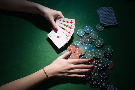 Female hands raking poker chipsの写真素材