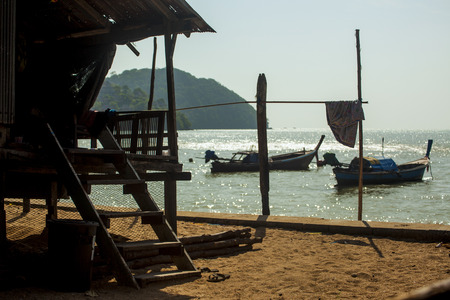 Fishermen houses are adjacent to the coast mountainsの写真素材