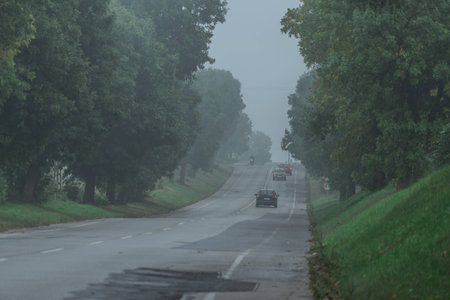 countryside slope road in fogの写真素材