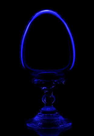 Crystal egg, surrounded by an aura of mystery, shines in the darkの写真素材