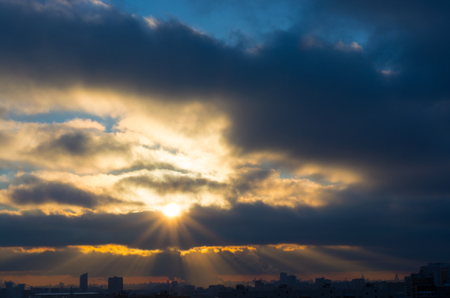 Moscow. The sun breaks through the heavy winter clouds and city lights up with bright rays.の写真素材