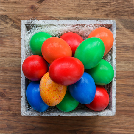 Colorful easter eggs in basket. Top viewの写真素材