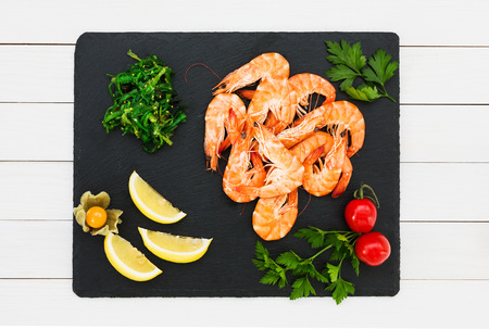 Cooked shrimps on slate stone plate. Top viewの写真素材