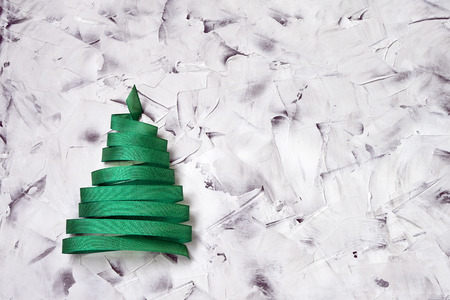 Christmas tree made from green ribbon on colorful background. Copy spaceの写真素材