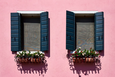 Italy, Venice, Burano island. Traditional colorful walls and windows with green shutters of the old houses. Copy spaceの写真素材