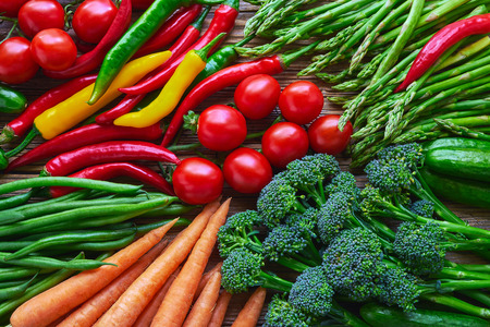 Vegetables background. Carrots, tomatoes, asparagus, broccoli, chilli pepper, green beans, cucumber. Top view. Healthy food background.の写真素材