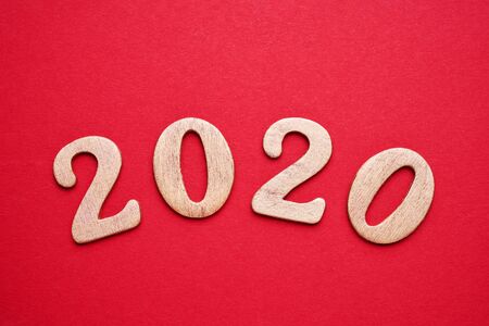 Golden 2020 on red background. Top view, copy space. Flat lay.