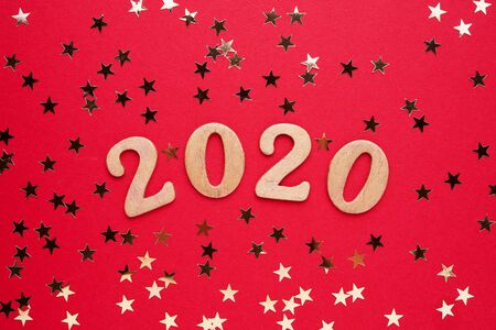 2020 on red background with golden sparkles. Top view, copy space. Flat lay.の写真素材