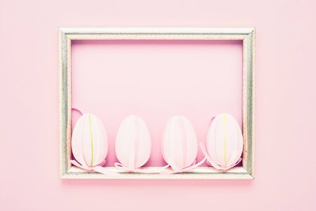 Easter background. Decorative pink Easter Eggs and tulip flowers on pink background. Top view, copy space for text. Easter celebration concept.の写真素材
