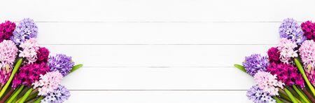 Holiday banner. Hyacinth flowers bouquet on white wooden background. Mother's day, Valentines Day, Birthday celebration concept. Top view, copy space for text.の写真素材