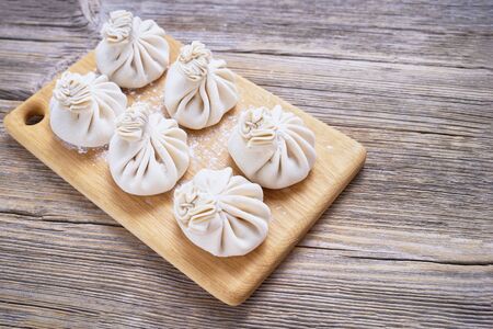 Georgian dumpling or Khinkali. Georgian homemade khinkali on cutting board. Top view, copy space for textの写真素材