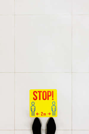 Stop point for customer to keep distance in the supermarket, to avoid spreading illness during transmission of COVID-19. Social distancing. Copy space for text, top view.の写真素材