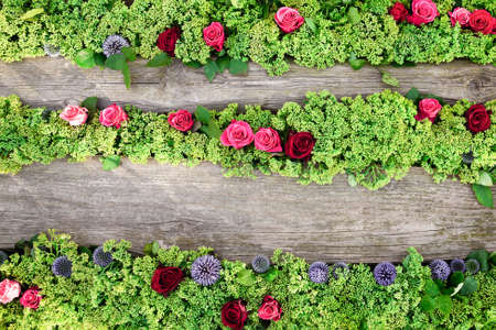 Flower background. Roses and stonecrop flowers on wooden background. Flat lay, copy space for textの写真素材