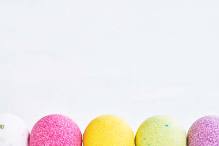 Colorful bath bombs on white background. Copy space for text.