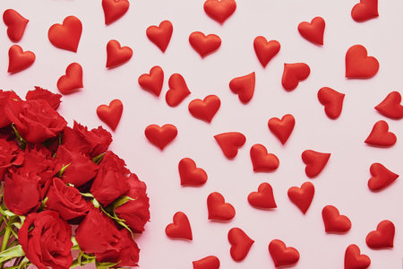 Valentines Day concept. Red hearts and red roses flower bouquet on a pink background. Flat layの写真素材