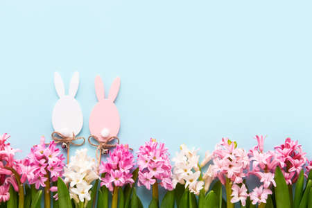 Easter background. Easter decoration and hyacinth flowers on a light blue background. Flat lay. copy...