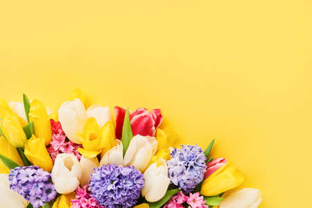 Spring flowers bouquet on a yellow background. Mothers day, Valentines Day, Birthday celebration concept.の写真素材
