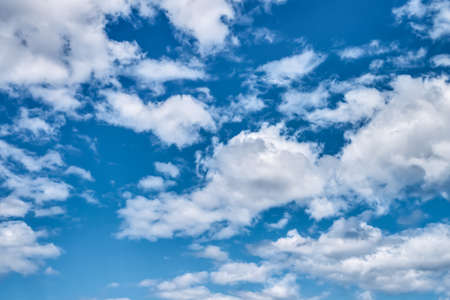 Fluffy clouds against the bright blue sky. Nature background. Copy spaceの写真素材