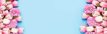 Frame of pink tulips and hyacinth on blue background. Mothers Day, Valentines Day, birthday conceptの写真素材