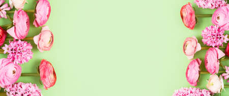 Pink ranunculus and hyacinths on green background. Banner. Mothers Day, Valentines Day concept