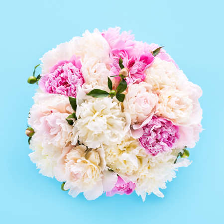 Bouquet of pink and white peonies on a light blue background. Holiday concept. Top view, soft focus