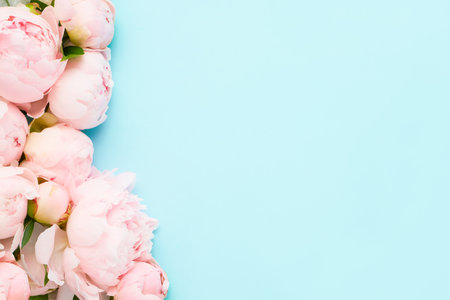 Bouquet of pink peonies on light blue background. Greeting card. Copy spaceの写真素材