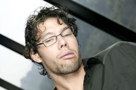 Young man with glasses making funny faceの写真素材