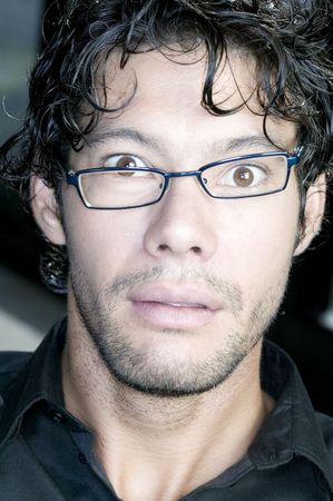 Young man with glasses making funny faceの写真素材