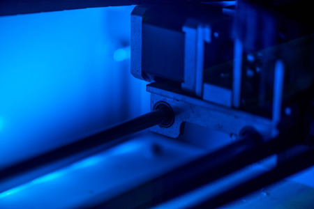 Working with 3D printer in the laboratory and studying technology. Printer is heating up. Macro shot of 3D printer, while printing a plastic product prototype by using white ABS filament. Innovation.の写真素材