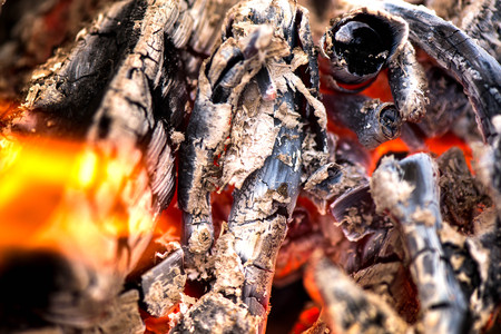 Ignite the fire. Warming up the cold winter nights. A macro shot of firewood, white dust and hot,...