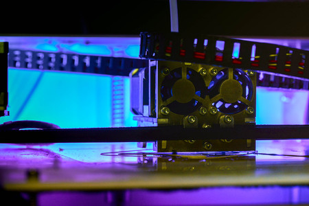 Working with 3D printer in the laboratory and studying technology. Printer is heating up. Macro shot of 3D printer, while printing a plastic product prototype by using white ABS filament. Innovation.の写真素材