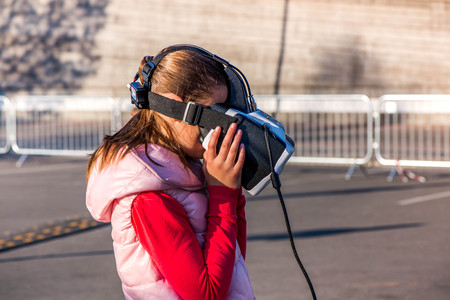 Beautiful young, little girl with virtual reality headset or 3d glasses. Women using VR glasses....
