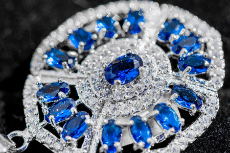 Macro shot of silver pendant with zircon stone and topaz on black background. Beautiful, handmade and expensive jewelry. Meditative, calming, healing and powerful crystalsの写真素材