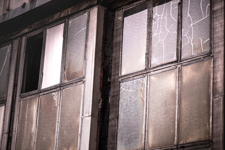A horror scene of damaged, old, scary and abandoned airplane shed, hangar, factory. Darkness,...