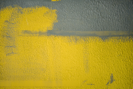 Half painted wall during renovation in house. Contrast background, yellow and greyの写真素材