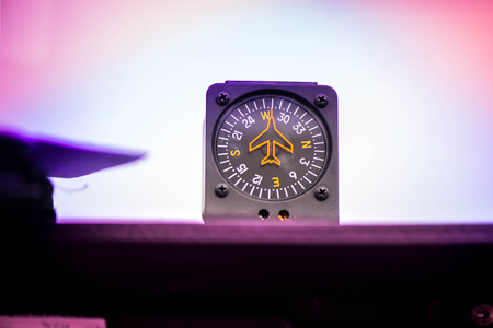 Macro shot of compass. Aircraft equipment, various indicators, buttons, instruments. The flight desk and control panel during take off and landing. Aircraft dashboard panel in pilot schoolの写真素材